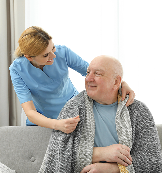 nurse-covering-elderly-man-with-blanket-1